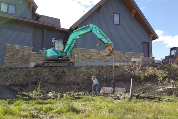Excavator preparing site for concrete work – Concrete Construction