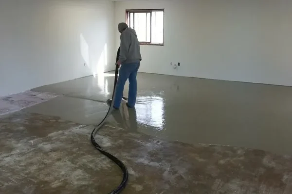 Contractor applying finish to concrete floor – Concrete Construction