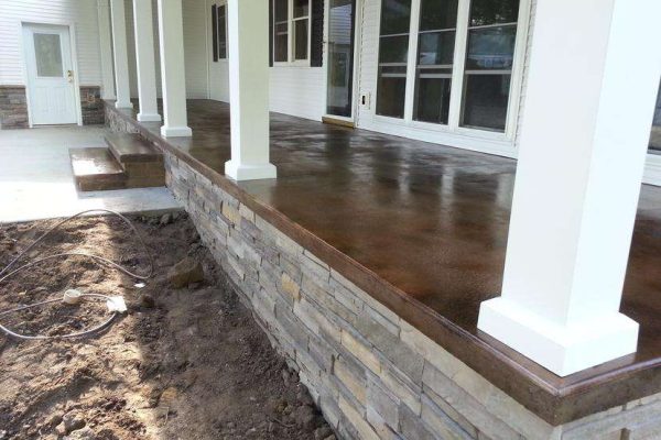 Polished stained concrete patio with stone edging – Concrete Construction